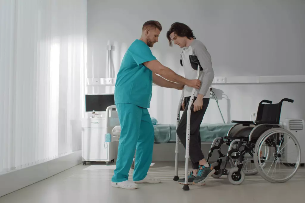 Male nurse helping disabled man walk