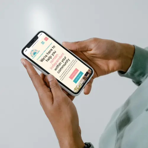 Person holding mobile phone with Corella Health website