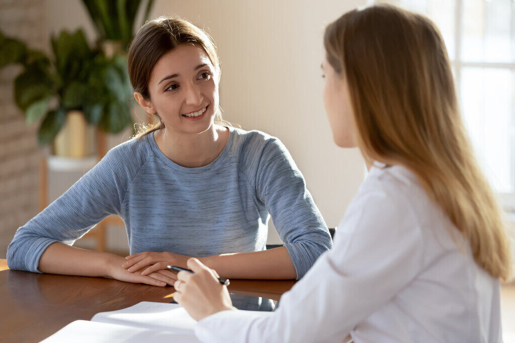 Two woman talking at table
